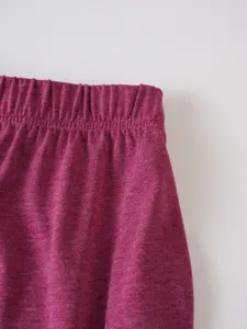 Close-up detail of men's casual shorts elastic waistband with vintage textured fabric surface.