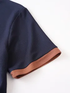 Close-up view of the contrast ribbed sleeve cuff on men blue waffle knit shirt detail