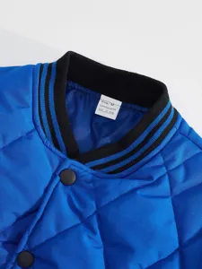 Detailed view of men's blue quilted jacket collar with striped rib and snap buttons.