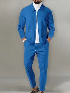 Detail view of men's waffle zip jacket and trousers set with white tee. Comfortable autumn outfit.