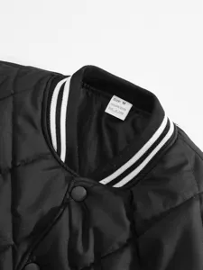 Close-up detail of black quilted jacket collar with ribbed striped trim and size tag.