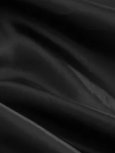 Black jacket fabric detail close up view, premium textured woven material display.
