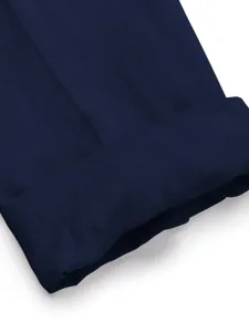 Close up detail shot of the dark blue linen fabric cuff or hem showing fine texture.