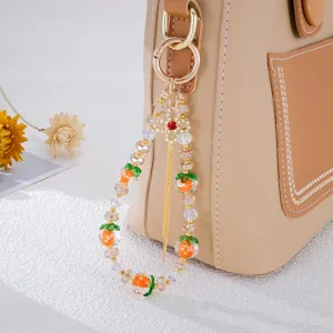Chinesischer Handy-Anhänger aus Perlen mit niedlichen orangefarbenen Persimone-Motiven
