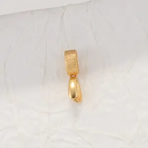 Close-up of golden brushed S925 silver pendant clasp with polished bail detail.