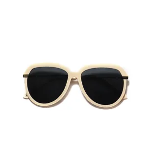 Classic aviator sunglasses featuring cream colored frames and black lenses for women