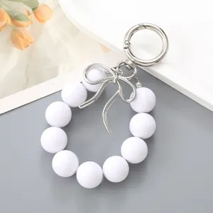 Korean style white beaded wrist keychain with silver bow charm for bags and phones