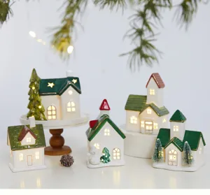 Detailed view of glowing ceramic Christmas village houses with festive warm lights.