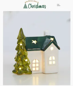 Close-up detail of a glowing white ceramic Christmas house with green tree decoration