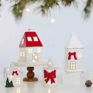 Christmas ceramic glowing house ornaments with red bows and warm LED lights