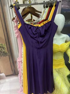 Detailed view of an elegant purple midi dress with a low-cut tie-front and ruched bust.