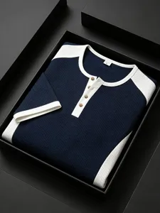 Close-up detail of color-blocked waffle knit short sleeve men's tee in black box presentation.