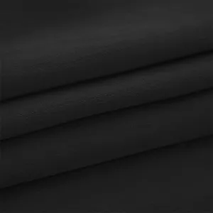 Black fabric material detail, premium texture close up view, apparel manufacturing material.