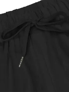 Black casual pants detail showcasing elastic waistband, adjustable drawstring and metal aglets.