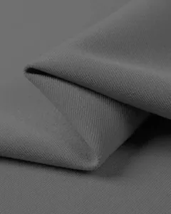 Close-up view of premium gray fabric texture with fine twill weave detail for apparel.