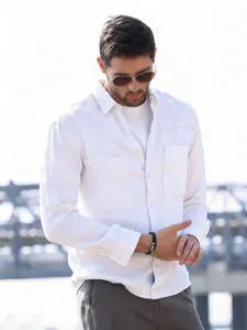 Men's white long-sleeve workwear shirt detail showing chest pocket and collar design.