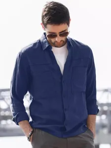 Close-up view of men's dark blue utility long sleeve shirt with double pockets.