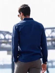 Back view detail of men's dark blue long sleeve casual shirt in comfortable fabric.