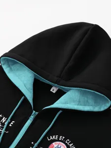 Men black zip-up hoodie detail view with contrasting turquoise inner hood lining and chest print.