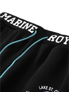 Black men's casual sweatpants detail shot with white elastic waistband lettering and blue drawstring.