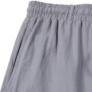 Vue detaillee pantalon decontracte lin gris ceinture poche texture tissu gros plan