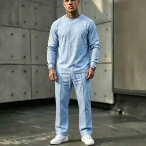 Men light blue linen casual long sleeve crewneck top and pants set for summer vacation.