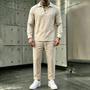 Detail view of men's casual linen V-neck long sleeve shirt and trousers set in beige.