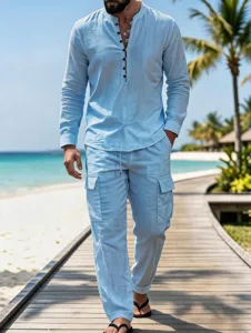 Detail shot of men light blue linen shirt and cargo trousers on a wooden beach walkway.