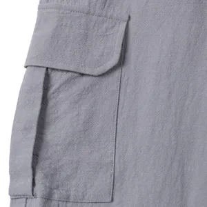 Men's casual cargo pants side pocket detail, breathable grey linen fabric texture close-up view.