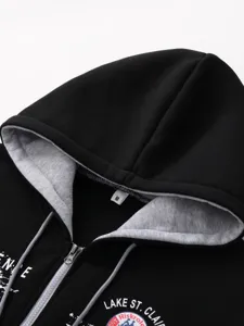Men's black zip-up hoodie with grey inner hood, drawstrings, and front graphic print detail.