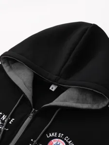 Detailed close-up view of black men's winter zip hoodie collar, hood and zipper texture.
