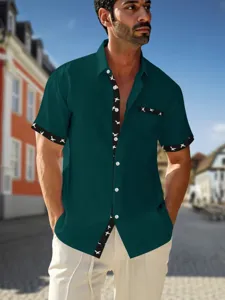 Men's short sleeve casual shirt, dark green with contrast bird print pattern, front view.