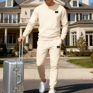 Détail de la tenue de sport beige avec sweat à col rond minimaliste et pantalon confortable.