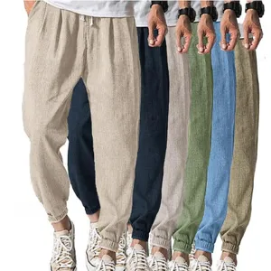 Men's casual loose linen-feel trousers with cuffed hem and adjustable drawstring for summer wear.