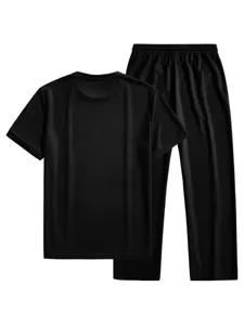 Close-up view of the black waffle knit fabric texture on the casual short sleeve apparel set.