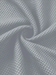 Grey waffle knit fabric close-up detail, soft textured material macro view for summer apparel.