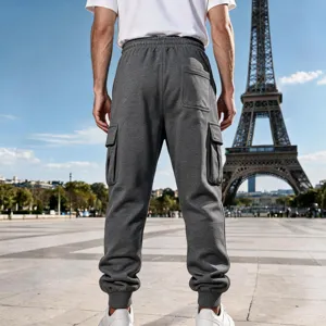 Detailed back view of men's dark grey cargo sweatpants with pockets in outdoor scene.