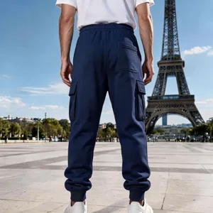 Detail view of men's dark blue fleece-lined cargo sweatpants showing back pockets and cuffs.