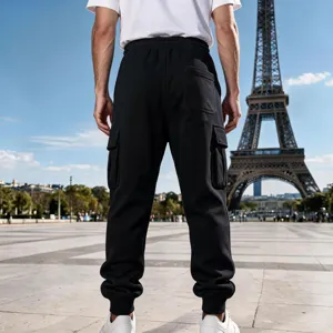 Detailed view of men's black cargo sweatpants, loose fit jogger trousers with side pockets.