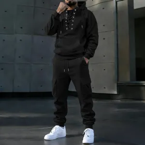 Detailed shot of black men's lace-up hoodie and multi-pocket cargo pants set in urban style.