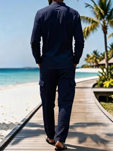 Detailed view of dark blue linen long sleeve shirt and pants on scenic beach boardwalk setting.