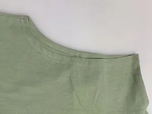 Sleeveless vest detail view, premium green fabric with fine stitching craftsmanship.