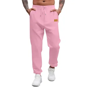 Pink cuffed sweatpants detail, comfortable drawstring waist, casual sports trousers view.