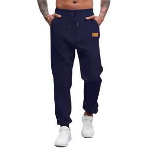 Men's dark blue casual joggers detail, elastic drawstring waist and pocket leather label.