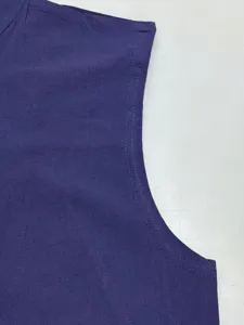 Close-up detail of purple sleeveless vest armhole stitching and textured fabric quality.