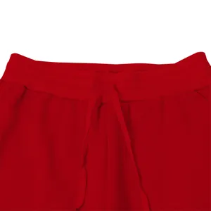 Red mens sweatpants detail view featuring elastic waistband and adjustable matching drawstring.