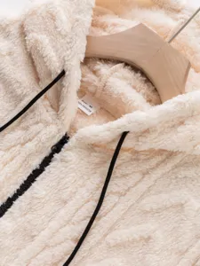 Close-up detail view of the soft beige plush fleece zip-up hoodie collar and fabric texture.