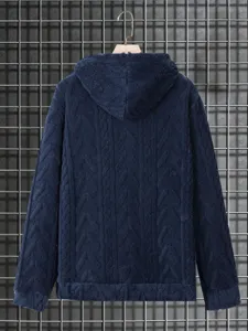 Detail view of a dark blue textured knit hooded sweatshirt, cozy fleece fabric and style.