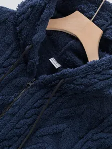 Detailed view of dark blue fleece zip hoodie, soft fuzzy texture and collar size tag.