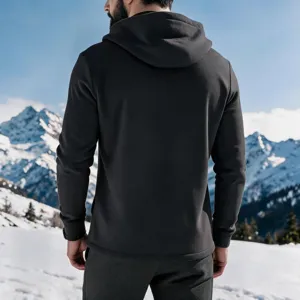 Back view of a mens fleece lined dark grey hoodie in snowy mountain outdoor scene.